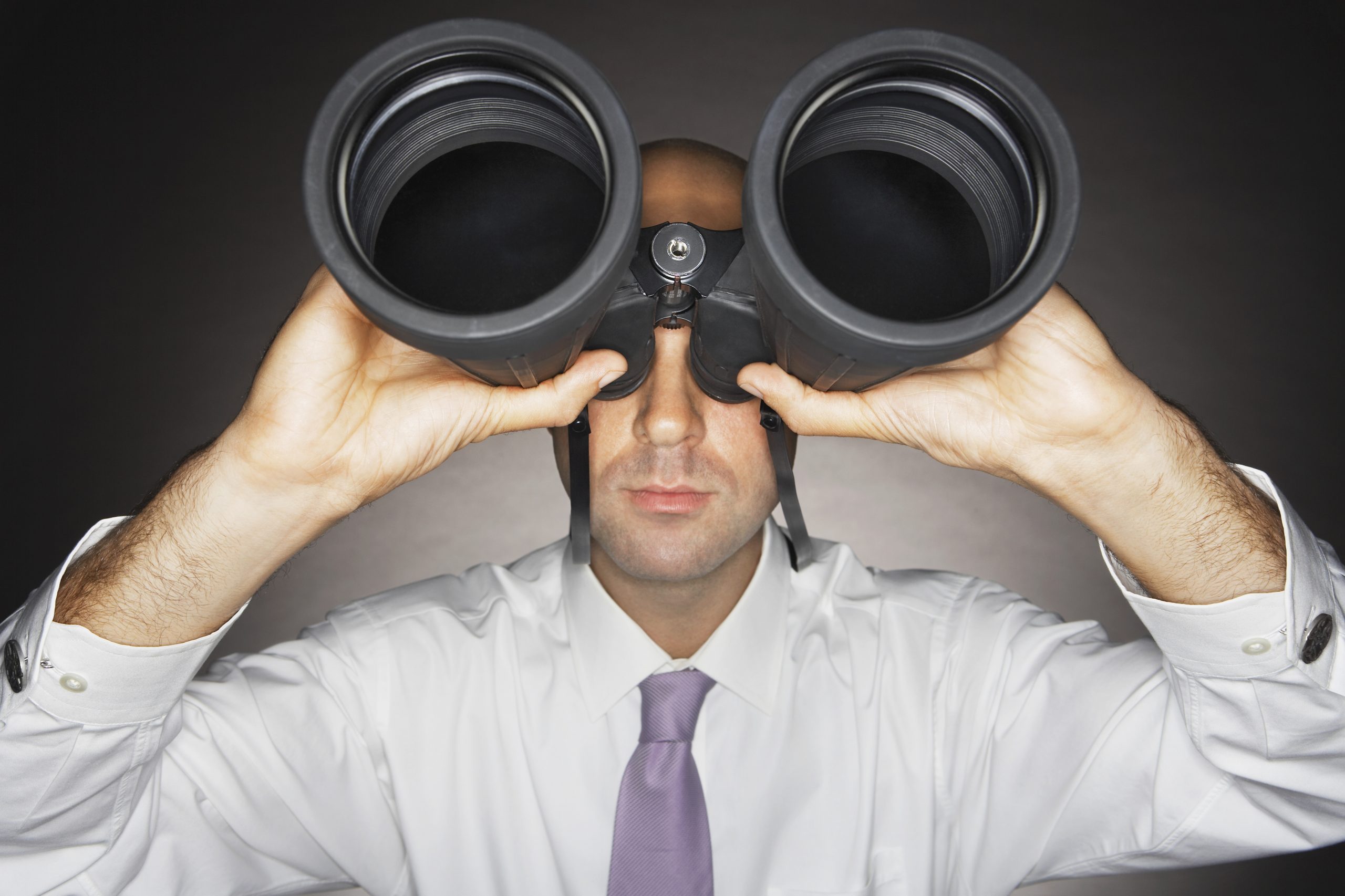 Businessman Holding Binoculars
